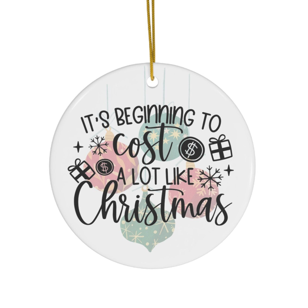 Round Christmas ornament with text 'It's beginning to cost a lot like Christmas' on a white background.