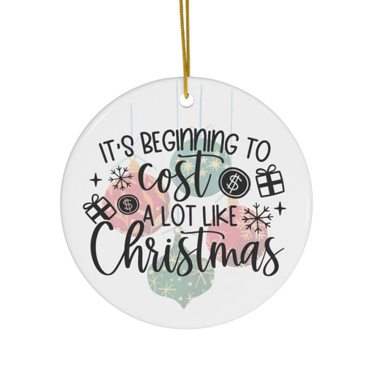 Round Christmas ornament with text 'It's beginning to cost a lot like Christmas' on a white background.