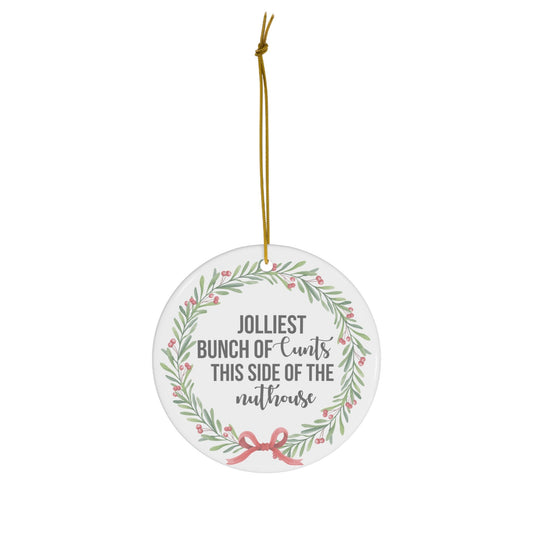 Round decorative ornament with text and floral design on a white background