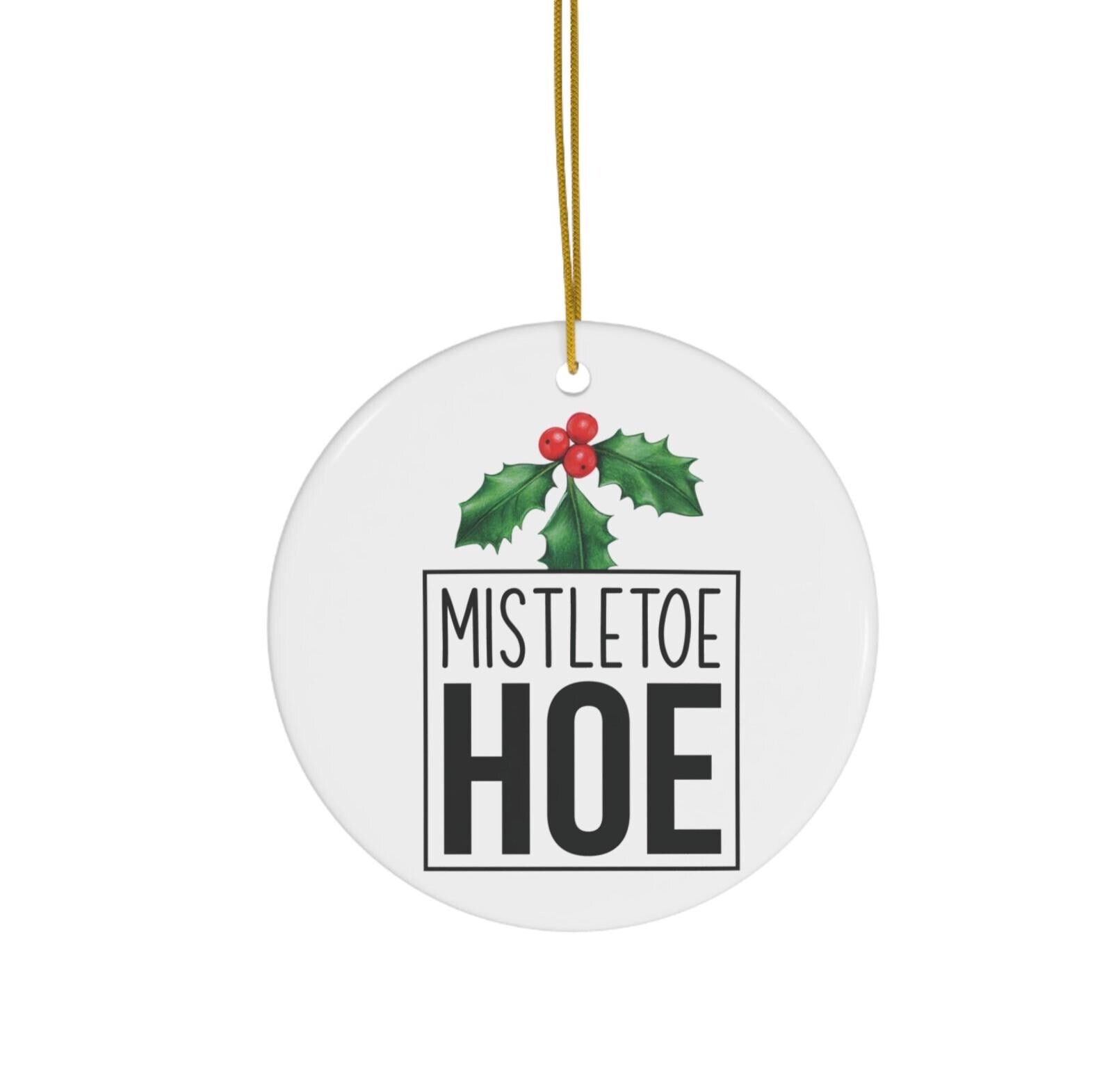Round white ornament with 'Mistletoe Hoe' text and holly design on a white background