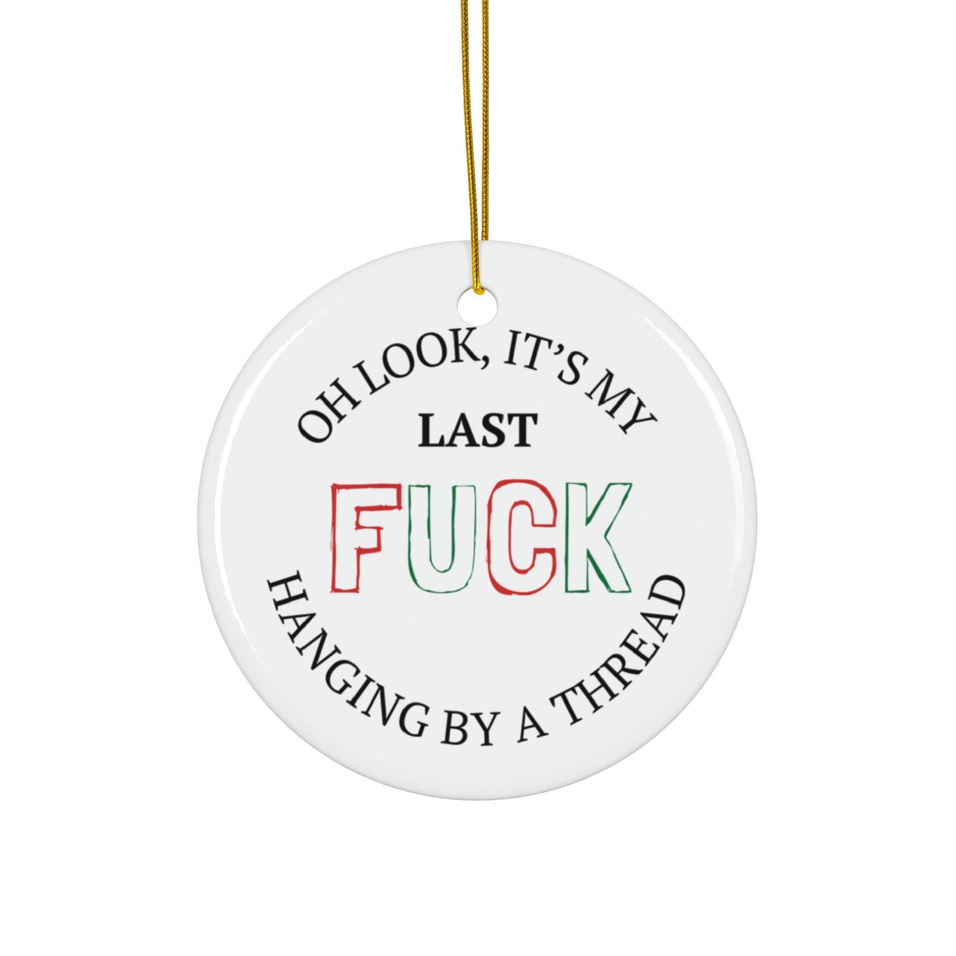 Round white ceramic ornament with humorous text design on a white background